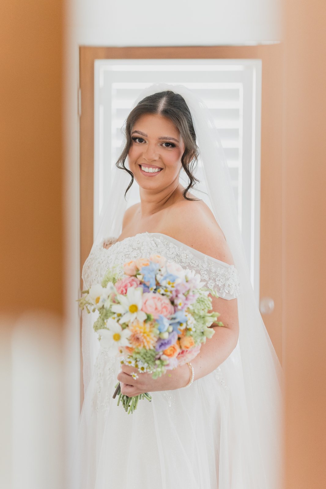 Smiling bride with colourful bouquet