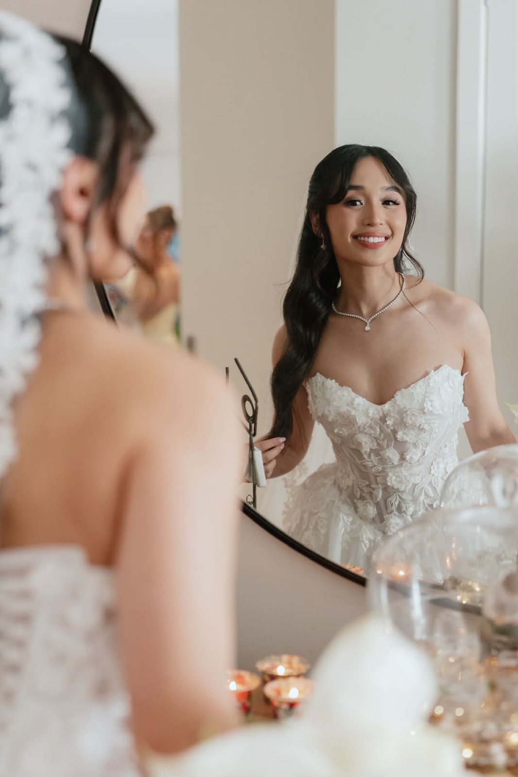 Bride smiling in the mirror