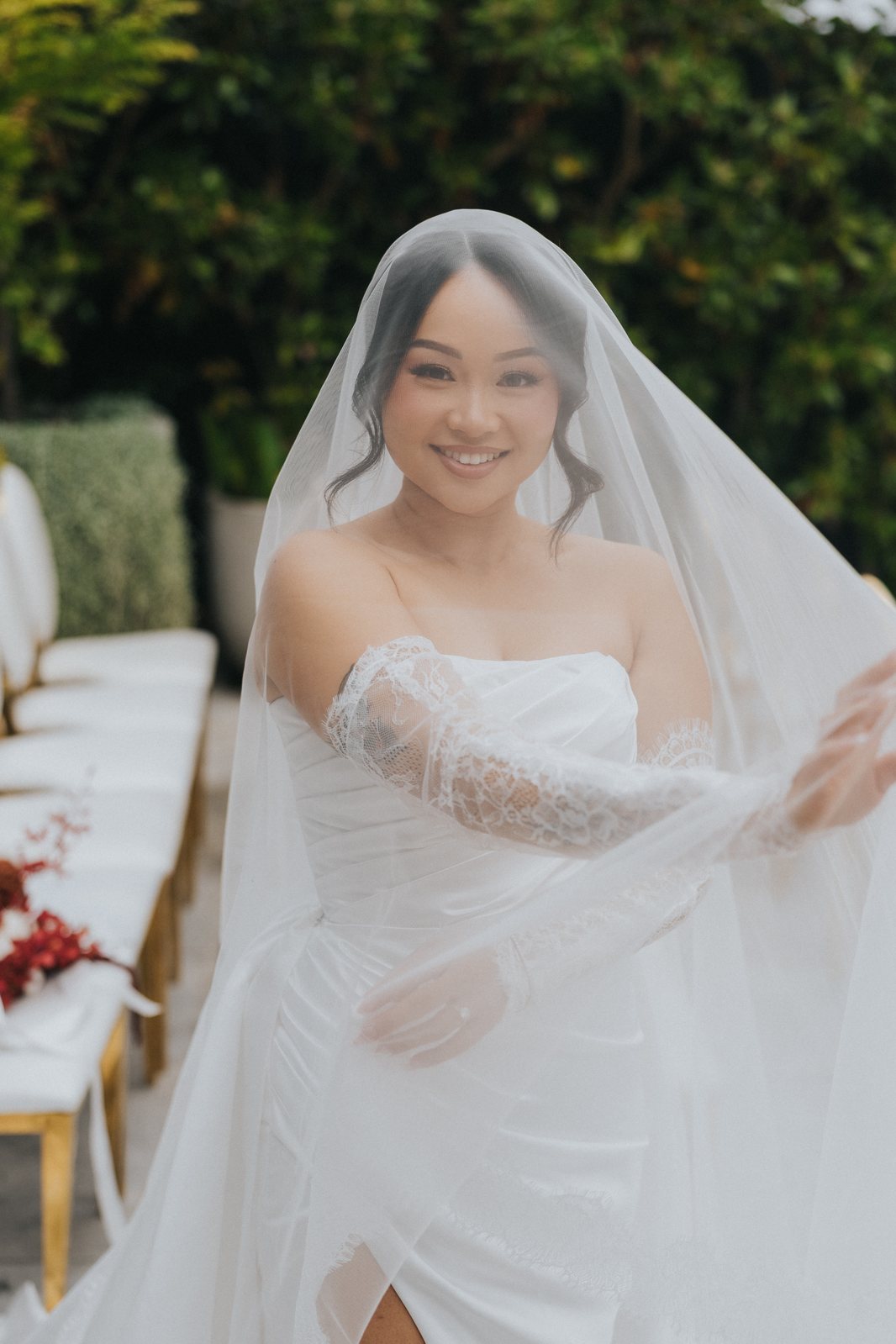 Bride smiling through her veil
