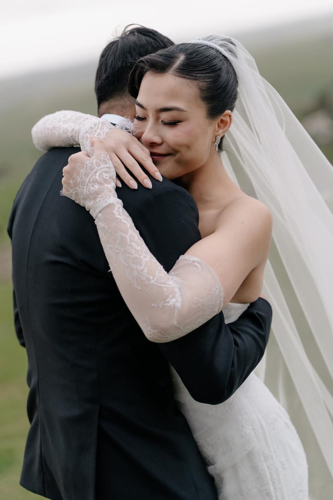 Couple embracing under veil